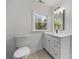 Bathroom features a stylish vanity, modern fixtures, and a bright window view at 1870 Avon Sw Ave, Atlanta, GA 30311