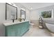 Modern bathroom with double sinks, stylish mirrors, and a soaking tub at 1870 Avon Sw Ave, Atlanta, GA 30311