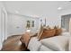Bright bedroom with light colored walls, wood floors and a door to the deck at 1870 Avon Sw Ave, Atlanta, GA 30311