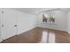 Bedroom with gleaming hardwood floors, white trim, and a bright window at 1870 Avon Sw Ave, Atlanta, GA 30311
