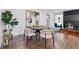 Elegant dining area featuring hardwood floors, modern décor, and a sleek bar cart, ideal for entertaining guests at 1870 Avon Sw Ave, Atlanta, GA 30311