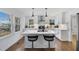 Modern kitchen with white cabinetry, stainless steel appliances, an island with seating, and hardwood floors at 1870 Avon Sw Ave, Atlanta, GA 30311