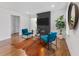 Stylish living room with hardwood floors, modern furniture, a tiled fireplace and a sleek entertainment area at 1870 Avon Sw Ave, Atlanta, GA 30311
