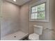 Modern bathroom features a tiled shower and a window providing natural light at 23 Club Dr, Locust Grove, GA 30248