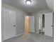 This bedroom has gray carpet, doors, and access to a bathroom at 23 Club Dr, Locust Grove, GA 30248