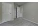 Bright bedroom showcasing neutral walls, carpet flooring, and a double door closet at 23 Club Dr, Locust Grove, GA 30248