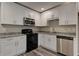 Modern kitchen with white cabinetry, granite countertops, and stainless steel appliances at 23 Club Dr, Locust Grove, GA 30248