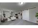 Living room features a sliding barn door and modern decor at 23 Club Dr, Locust Grove, GA 30248