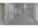 Open-concept living room with neutral walls, new carpet and multiple entryways for easy navigation at 23 Club Dr, Locust Grove, GA 30248