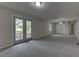 Large living room with doors to the backyard and a ceiling fan at 23 Club Dr, Locust Grove, GA 30248
