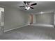Large living room featuring neutral walls, ceiling fan, and plush carpeting at 23 Club Dr, Locust Grove, GA 30248