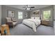 Stylishly staged main bedroom featuring neutral walls, new carpet, and large windows at 23 Club Dr, Locust Grove, GA 30248