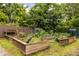 Backyard garden beds, constructed from wood and metal, grow fruits and vegetables in a green space at 297 Atlanta Se Ave # 8, Atlanta, GA 30315