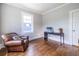 Bedroom featuring rich hardwood flooring and a cozy leather armchair at 297 Atlanta Se Ave # 8, Atlanta, GA 30315