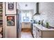 Efficient galley kitchen with white cabinets, subway tile, and modern appliances under bright lighting at 297 Atlanta Se Ave # 8, Atlanta, GA 30315