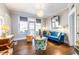 Inviting living room featuring hardwood floors, a blue velvet sofa, and an artistic light fixture at 297 Atlanta Se Ave # 8, Atlanta, GA 30315