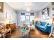 Bright living room featuring hardwood floors, a blue velvet sofa, and a unique floral-patterned armchair at 297 Atlanta Se Ave # 8, Atlanta, GA 30315