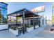Outdoor patio area with picnic tables and a modern awning structure at 297 Atlanta Se Ave # 8, Atlanta, GA 30315