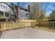 Paved backyard with newly built wooden fence and surrounding greenery at 958 Austin Ne Ave, Atlanta, GA 30307