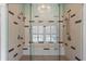 Contemporary bathroom showcasing a glass shower with dual shower heads, built-in bench, and modern chandelier at 958 Austin Ne Ave, Atlanta, GA 30307