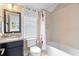 Bathroom featuring a granite countertop, mirror, tile surround and shower curtain at 958 Austin Ne Ave, Atlanta, GA 30307