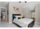 Bedroom with ceiling fan, decorative wall art, and bed with a padded headboard at 958 Austin Ne Ave, Atlanta, GA 30307