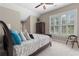 Bedroom featuring a platform bed with decorative pillows, shuttered windows and ceiling fan at 958 Austin Ne Ave, Atlanta, GA 30307