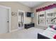 Bright bedroom with a flat screen TV, couch, and access to a bathroom at 958 Austin Ne Ave, Atlanta, GA 30307