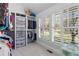 Bright walk-in closet with custom shelving, storage drawers and window with plantation shutters at 958 Austin Ne Ave, Atlanta, GA 30307
