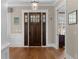 Elegant foyer with a hardwood floor, a dark wood front door with sidelights and transom, and neutral walls at 958 Austin Ne Ave, Atlanta, GA 30307