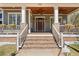 Inviting front porch with brick stairs, white railings, and decorative flower boxes, leading to the front door at 958 Austin Ne Ave, Atlanta, GA 30307