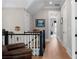 Upstairs hallway with hardwood floors, neutral walls, black and white banister, and view to other rooms at 958 Austin Ne Ave, Atlanta, GA 30307