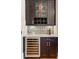 Kitchen wet bar features a wine refrigerator, wine rack, glassware storage, and dark wood cabinets at 958 Austin Ne Ave, Atlanta, GA 30307