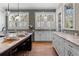 This bright kitchen features an island with seating, a light backsplash, stainless appliances, and plenty of natural light at 958 Austin Ne Ave, Atlanta, GA 30307