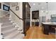Kitchen featuring dark wood cabinets, wine fridge and stainless appliances is located steps from the staircase at 958 Austin Ne Ave, Atlanta, GA 30307