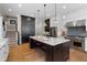 Bright and airy kitchen featuring a center island with seating, stainless appliances, and light wood floors at 958 Austin Ne Ave, Atlanta, GA 30307