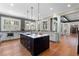 Spacious kitchen features a center island, stainless steel appliances, hardwood floors, and a view to the entry hall at 958 Austin Ne Ave, Atlanta, GA 30307