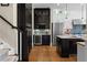 Kitchen features dark wood cabinets and wine fridge in addition to a center island and stainless appliances at 958 Austin Ne Ave, Atlanta, GA 30307