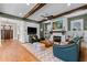 Spacious living room with hardwood floors, exposed wood beams, fireplace, and comfortable seating at 958 Austin Ne Ave, Atlanta, GA 30307