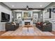 Bright living room with hardwood floors, fireplace with white mantel, comfortable seating, and stylish decor at 958 Austin Ne Ave, Atlanta, GA 30307