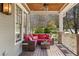 Cozy outdoor porch featuring comfortable seating, a small table, and views of the surrounding greenery at 958 Austin Ne Ave, Atlanta, GA 30307