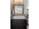 Powder room featuring a black vanity cabinet with granite countertop and framed mirror at 958 Austin Ne Ave, Atlanta, GA 30307