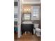 Powder room featuring a black vanity cabinet with granite countertop and framed mirror at 958 Austin Ne Ave, Atlanta, GA 30307