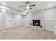 Finished basement features a white brick fireplace, wood flooring, and a ceiling fan at 1277 Muirforest Dr, Stone Mountain, GA 30088