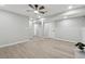 Finished basement with neutral tones, wood-look flooring, and ample lighting for a versatile living space at 1277 Muirforest Dr, Stone Mountain, GA 30088