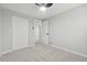 Bright bedroom features a ceiling fan, neutral carpet, and a large closet for ample storage at 1277 Muirforest Dr, Stone Mountain, GA 30088
