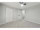 Inviting bedroom features plush carpeting, a ceiling fan, and offers access to an adjacent bathroom at 1277 Muirforest Dr, Stone Mountain, GA 30088