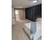 Bright bedroom featuring a barn door, a dark blue accent wall, and carpeted floors at 1277 Muirforest Dr, Stone Mountain, GA 30088