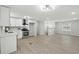 An open-concept design seamlessly integrates a modern kitchen with stainless steel appliances to the home's living space at 1277 Muirforest Dr, Stone Mountain, GA 30088