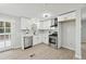 Bright kitchen features stainless steel appliances, white cabinetry, and modern fixtures at 1277 Muirforest Dr, Stone Mountain, GA 30088